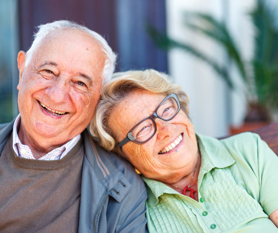 Older man and his adult daughter smile as they discuss updating his estate plan in the new year.