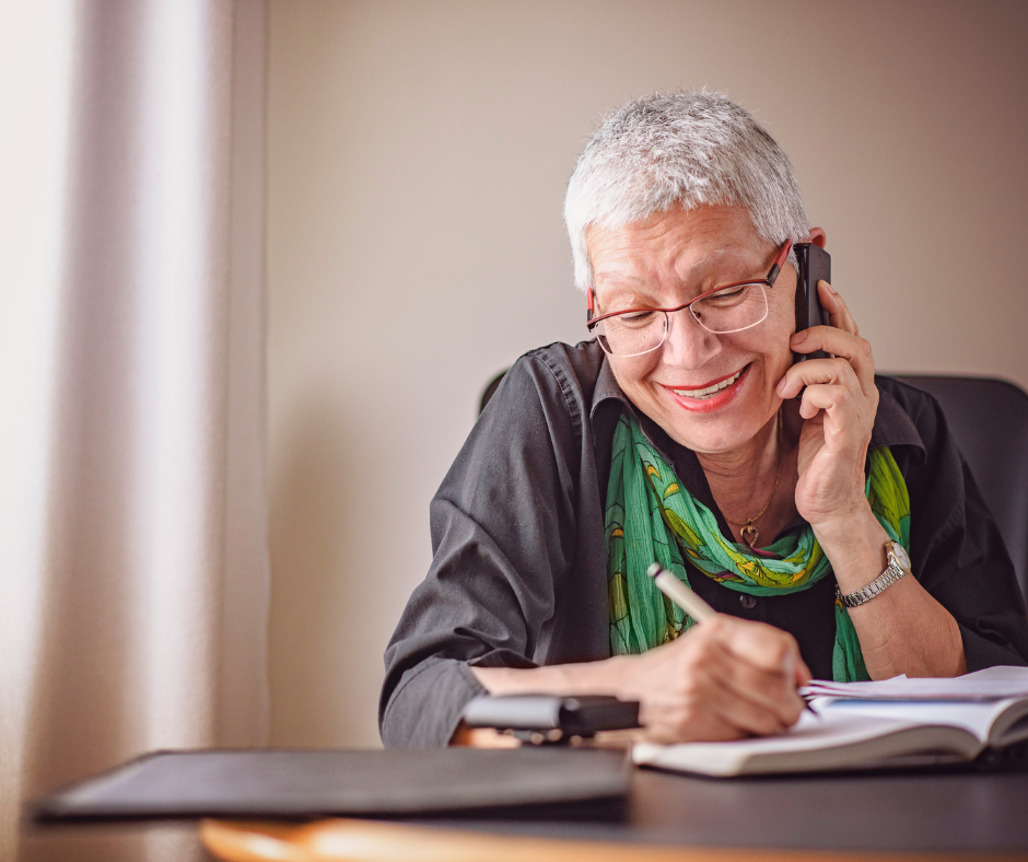 Older woman talking on the phone and getting her estate planning completed.