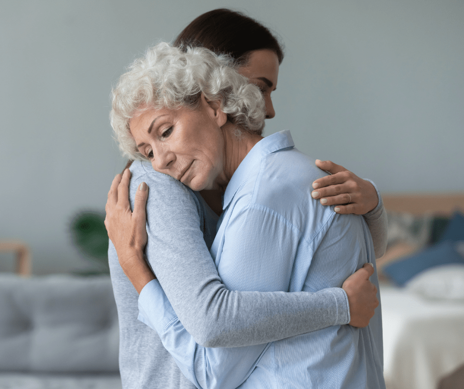 Grandmother hugging her adult son, discussing inherited IRAs.